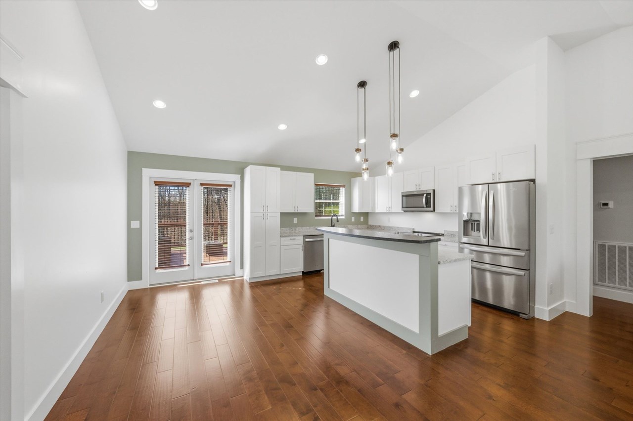 modern kitchen large island with granite counter top, new appliances, modern cabinets